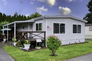 home exterior with grass and bushes