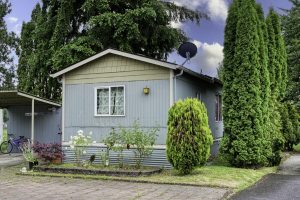 home exterior with grass and bushes