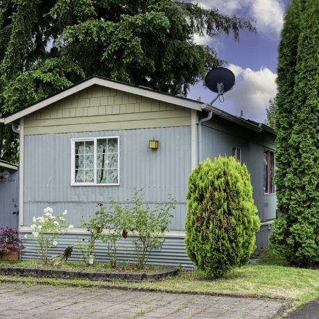 home exterior with grass and bushes