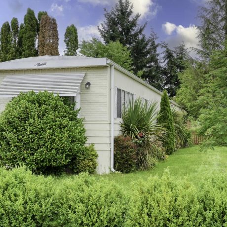 home exterior with grass and bushes