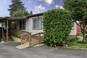 home exterior with grass and bushes