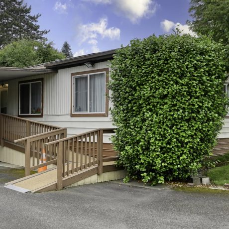 home exterior with grass and bushes